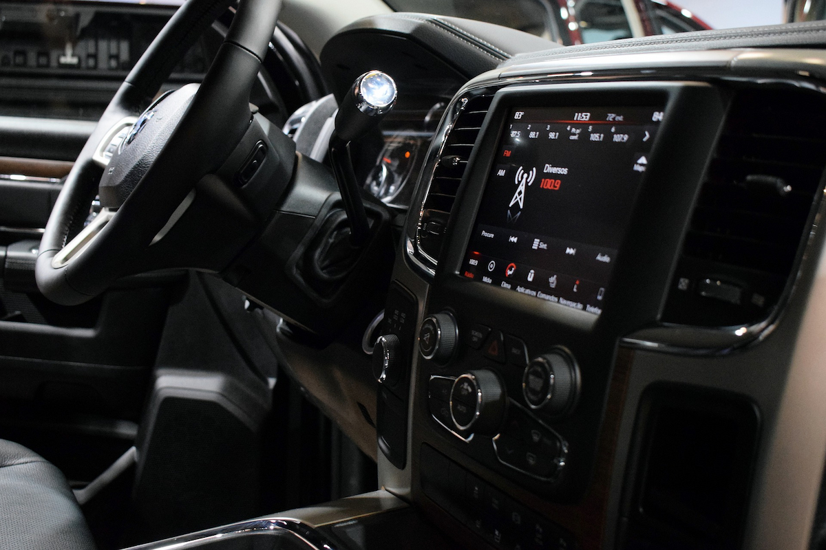 The interior of Dodge Ram shows the dashboard, dash screen, and steering wheel.