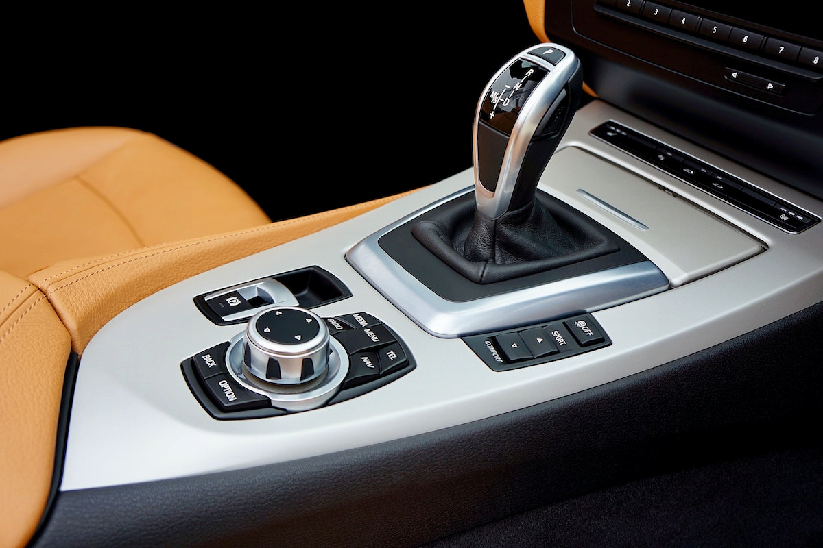 a gray vehicle's gear shift knob together with other buttons
