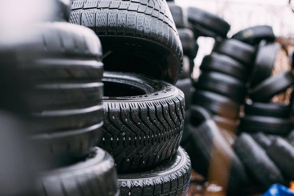 a pile of used tires with different styles and sizes seen inside a room