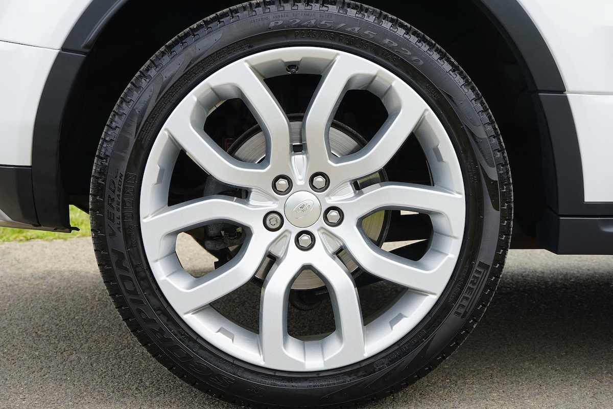 a close-up image of a white car's wheel
