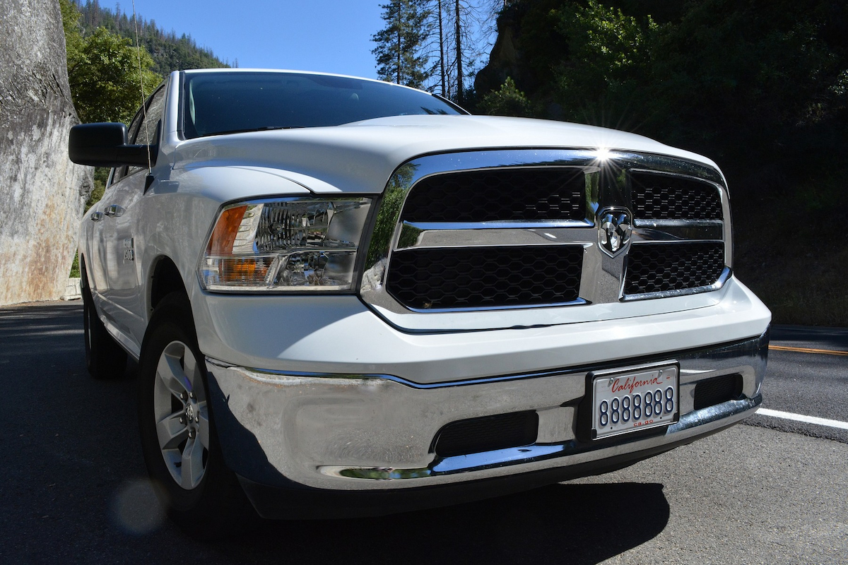 a white dodge ram pickup is parked in the middle of a road