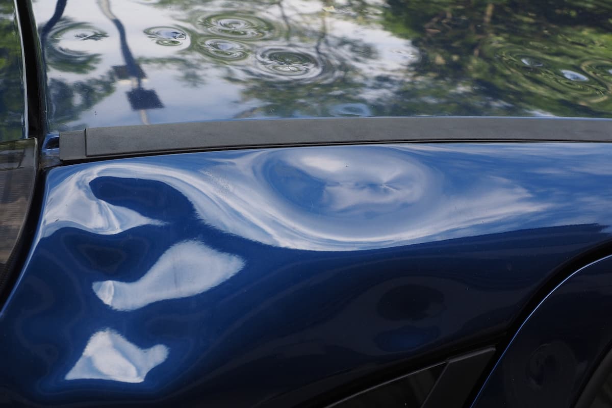 Close-up photo of a damaged frame of a car.