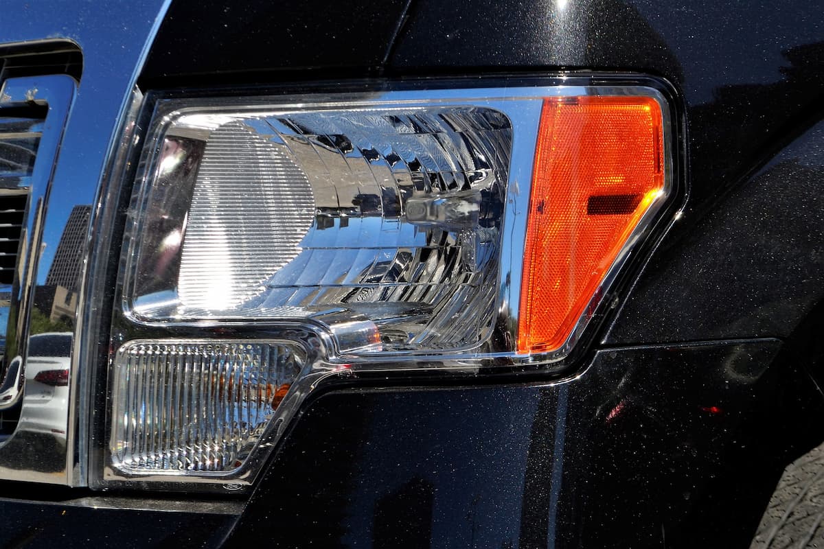 A close-up photo of a vehicle's headlamp and signal lights. 
