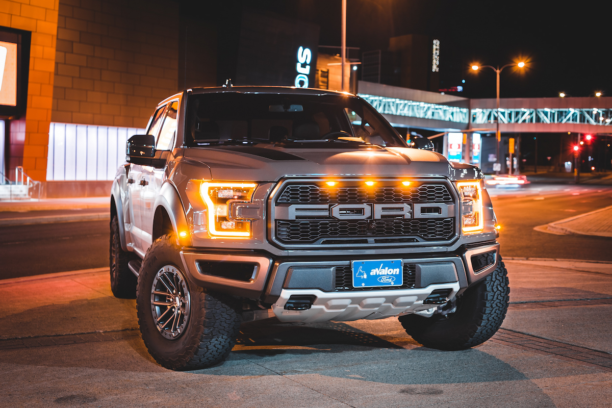 A Ford pickup truck parked on a street at night.