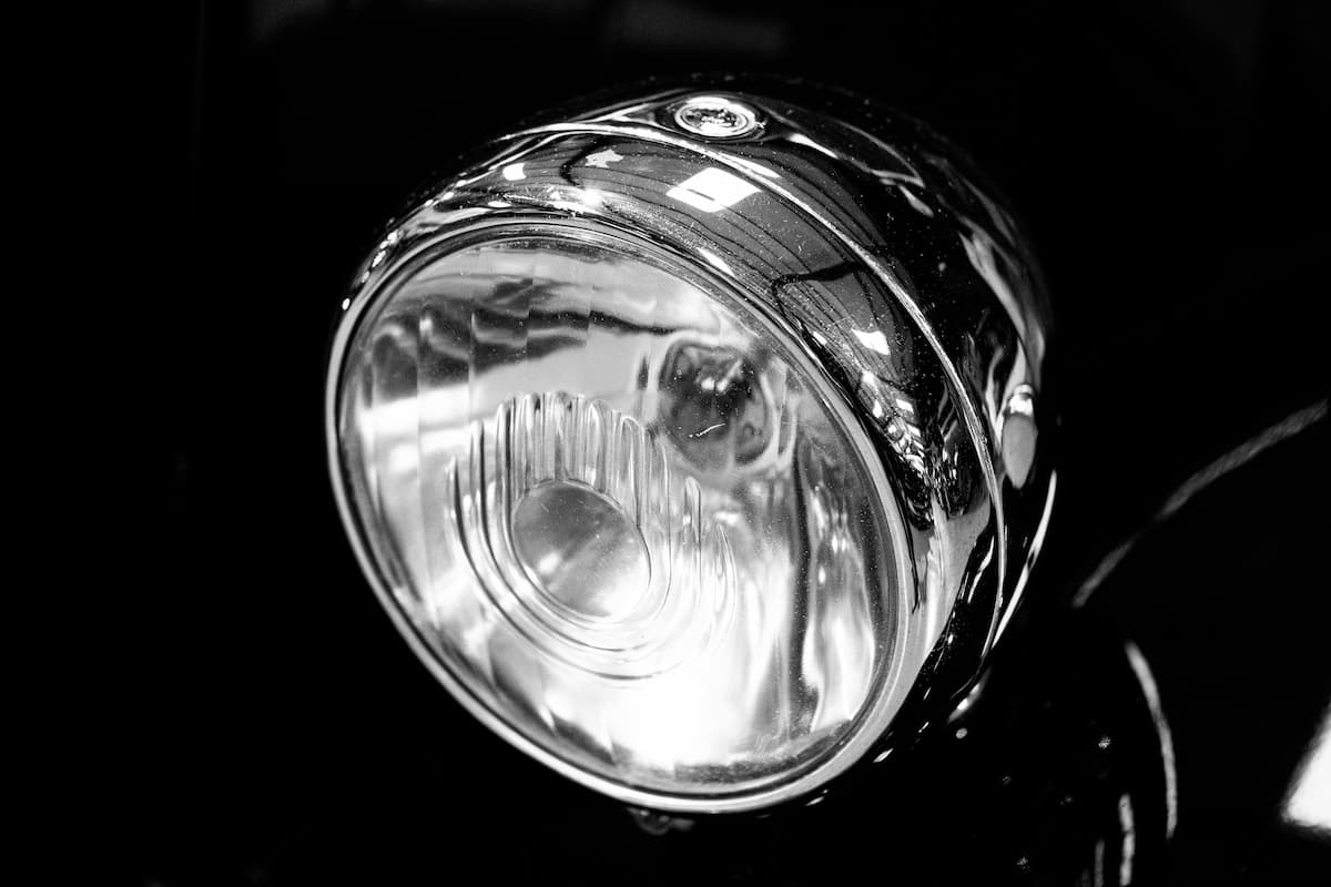 A black and white photo of a headlight bulb. 