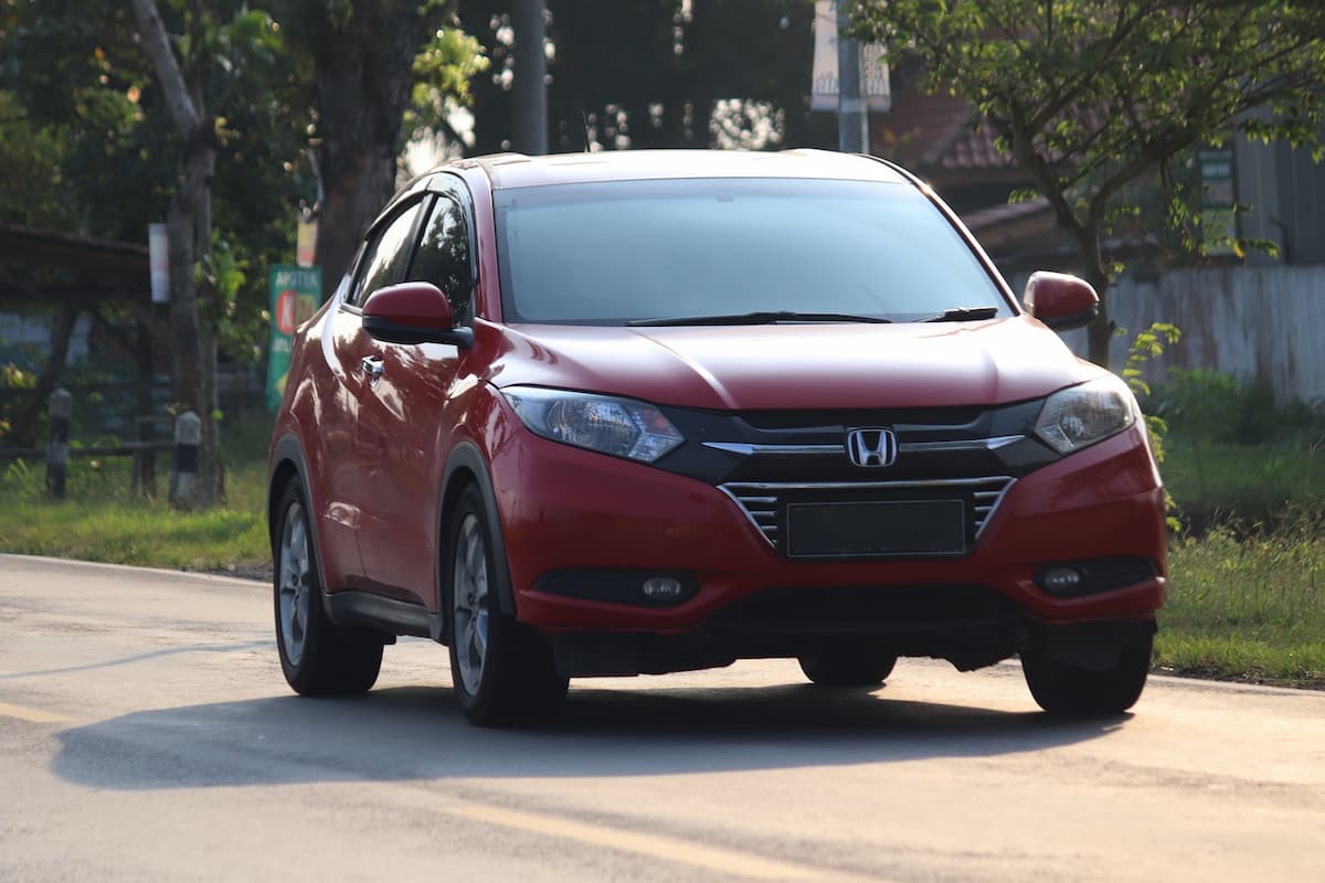 A red Honda Civic on the road. 