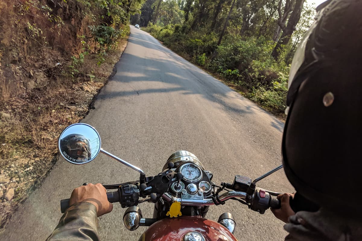 A man wearing a helmet is riding a motorcycle.