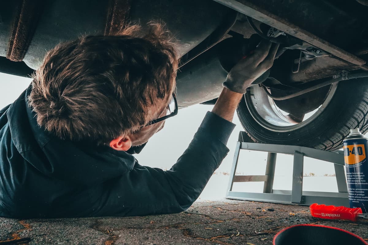 A man working underneath the car making repairs.