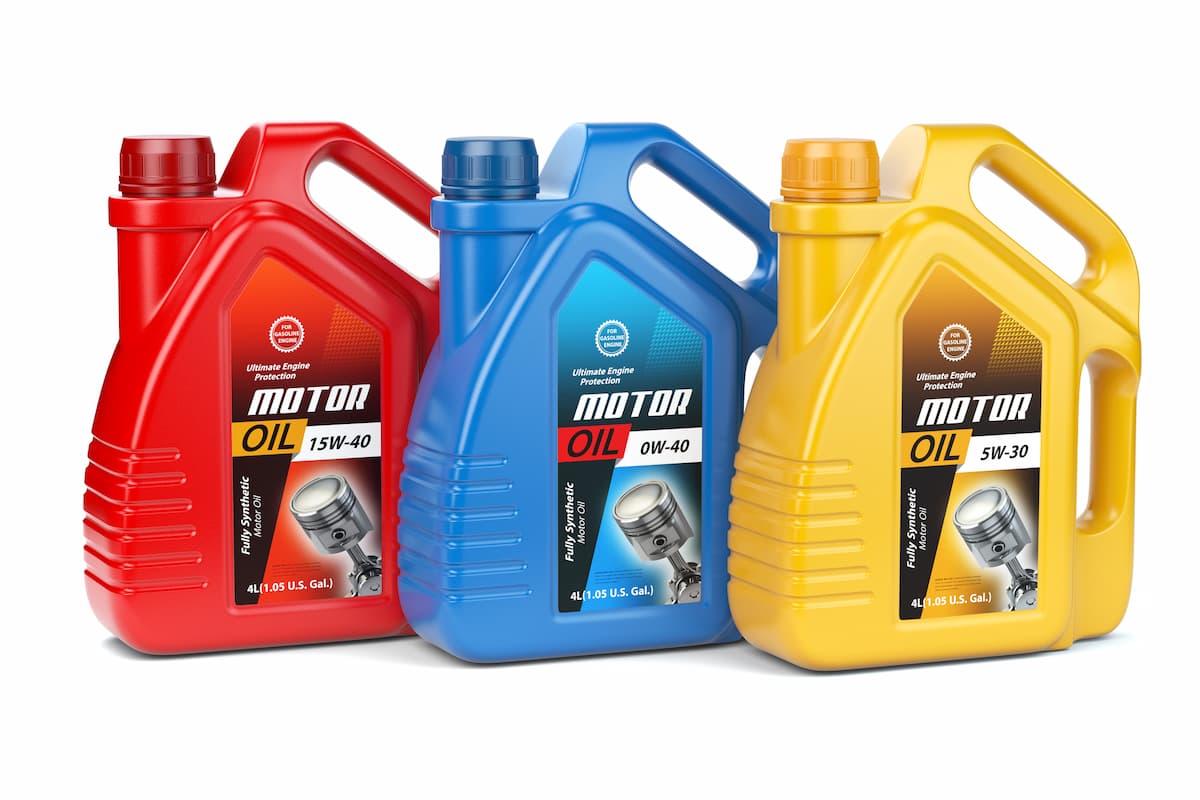 Motor oil containers in red, blue, and yellow against a white backdrop.