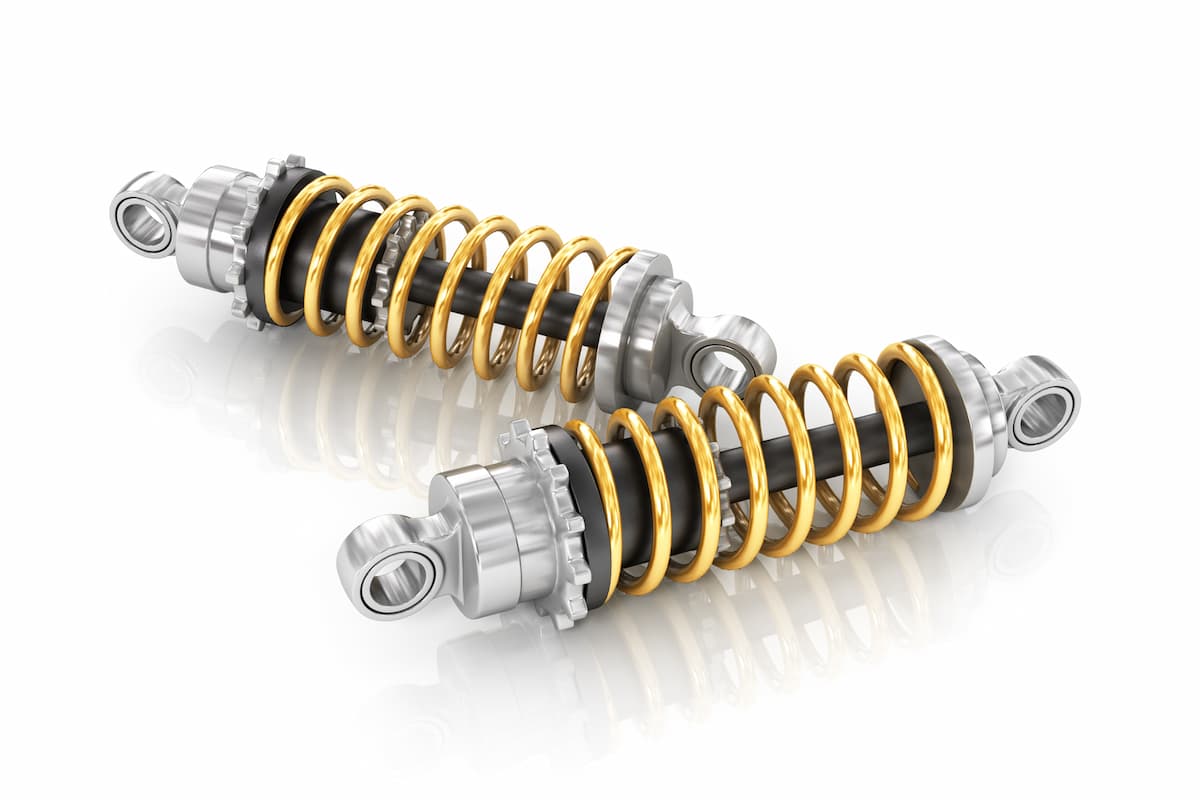 Two new shock absorbers on a white background. 