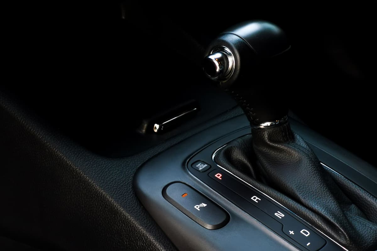 Close-up photo of the gear shift lever of a car in Park mode. 