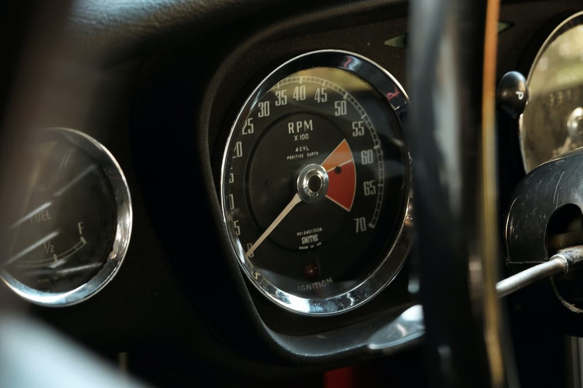 Close-up photo of a tachometer of a classic car. 