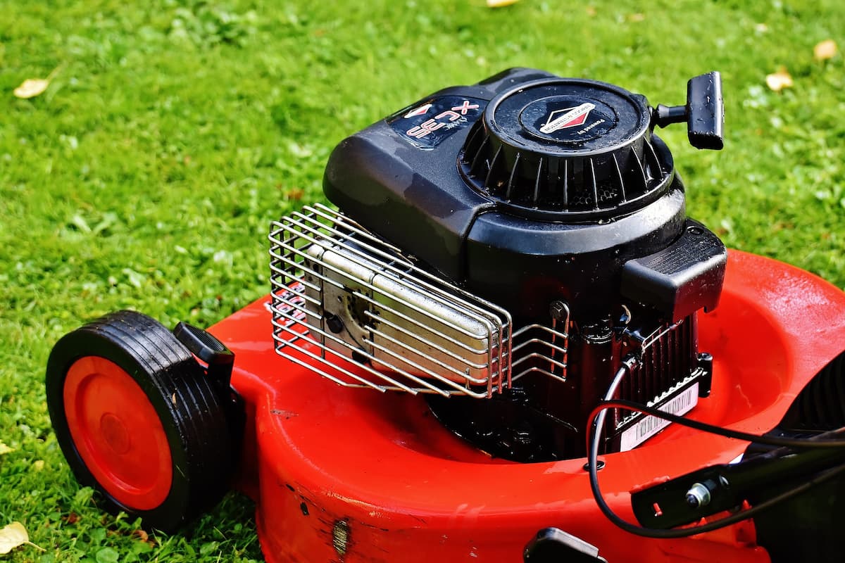 Close-up photo of a lawn mower on the grass. 