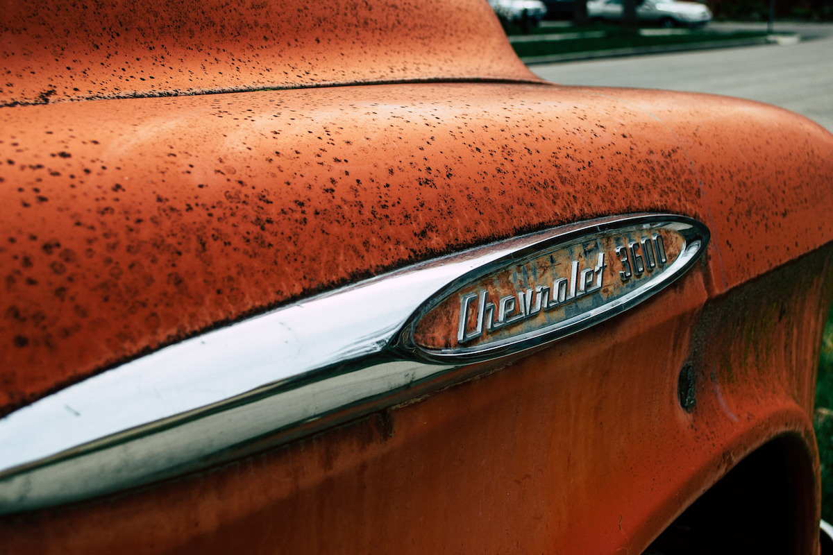 Close-up photo of a rusty, orange Chevrolet 3600.