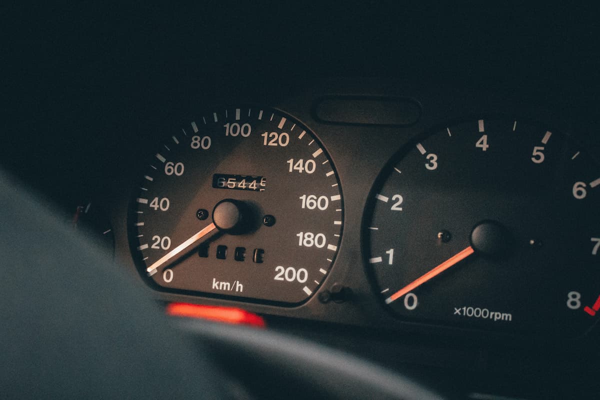 Close-up photo of a car's speedometer and tachometer.