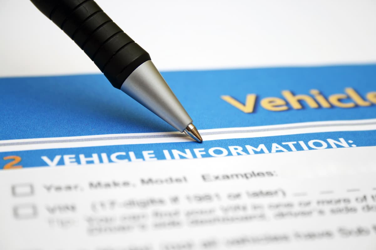 Close-up photo of a vehicle information form and a black pen. 